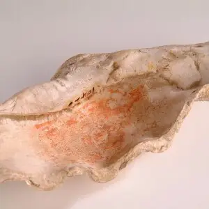 Shell of the Giant Clam (Tridacna gigas) from the Red Sea reused as a container for red paint made form ochre (iron oxide), plant oil and plant gum, a similar recipe to that used in a tomb in the Valley of the Kings, Thebes. Egyptians often used natural o